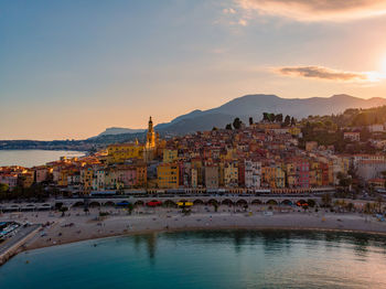 Buildings in city at sunset