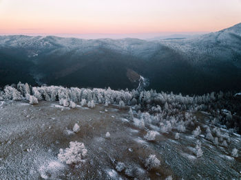 Scenic view of snowcapped mountains against sky during sunset