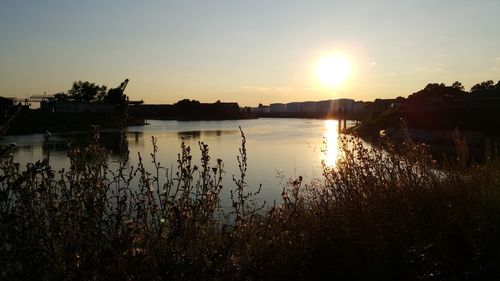 Scenic view of lake against sky during sunset