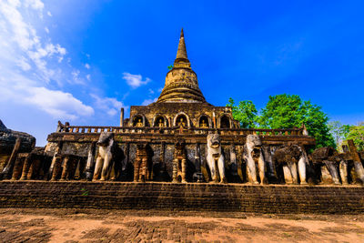 Low angle view of historical building against blue sky