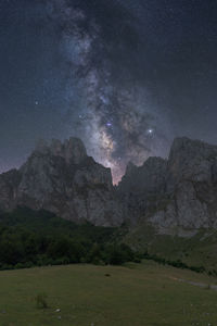 Scenic view of mountains against sky at night