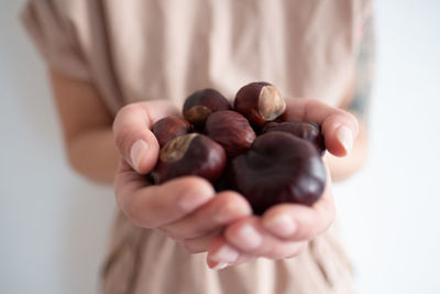 Midsection of woman holding chestnuts