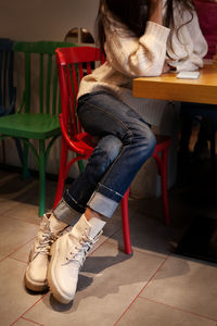 Women's fashion casual clothing. legs in denim pants and high leather ankle boots with laces