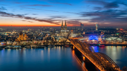 Aerial view of city lit up at sunset