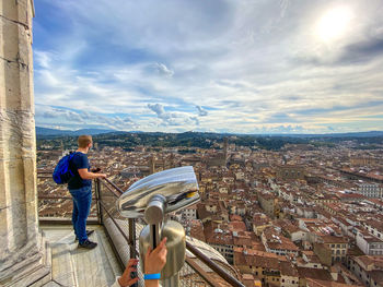 Rear view of man looking florence at cityscape against sky