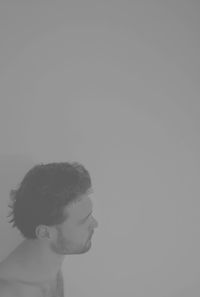 Close-up of boy against white background
