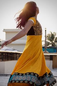 Side view of woman dancing on building terrace