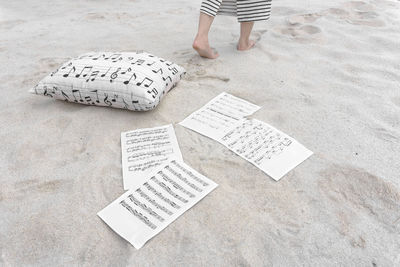 Low section of man with text on sand