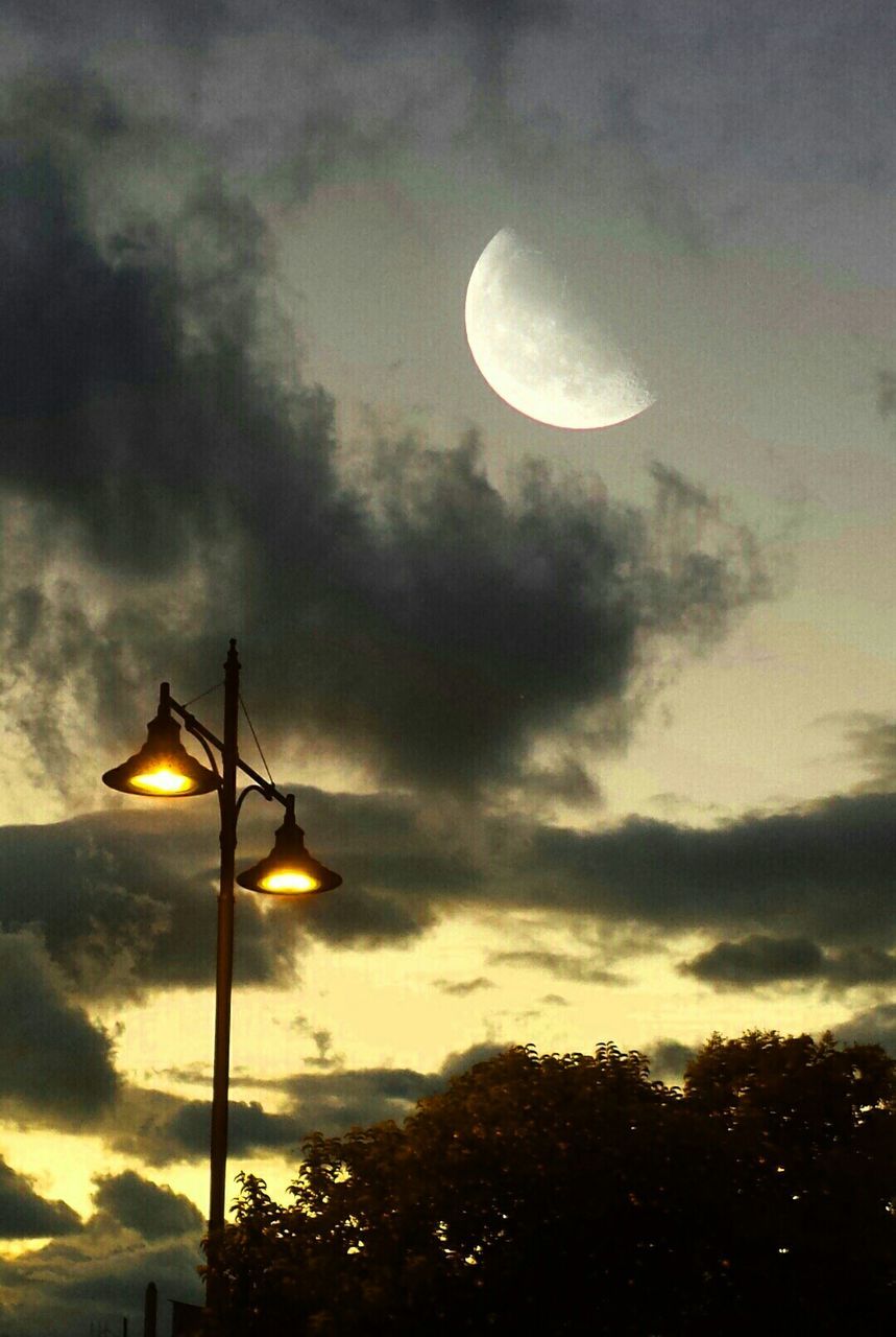 low angle view, street light, sky, lighting equipment, cloud - sky, silhouette, illuminated, cloudy, sunset, tree, nature, cloud, electric light, dusk, electricity, beauty in nature, scenics, tranquility, lamp post, outdoors