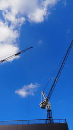 Low angle view of crane against sky