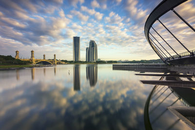 Reflection of buildings in lake against sky