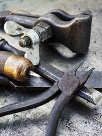 Close-up of various rusty tools on metal table