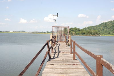 Pier over lake against sky