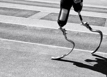 Low section of person with prosthetic leg on street