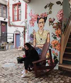 Portrait of young woman sitting outdoors