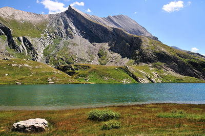 Scenic view of lake and mountains against sky