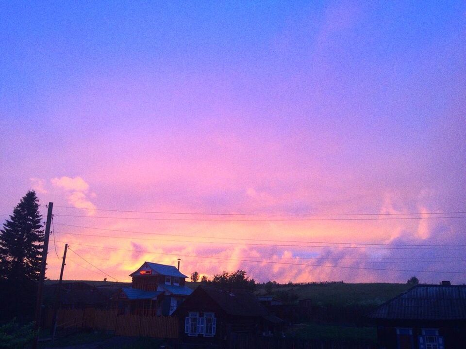 SILHOUETTE BUILDINGS AGAINST DRAMATIC SKY AT SUNSET