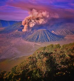 Smoke emitting from volcanic mountain against sky