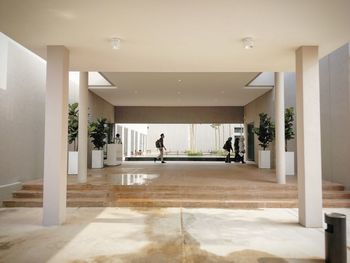 People walking in corridor of building