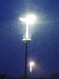 Low angle view of illuminated street light against sky at night