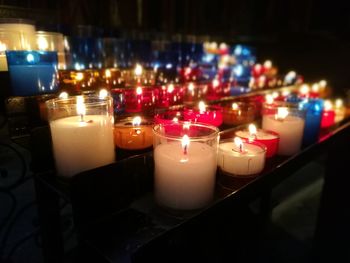 Close-up of lit tea light candles at night