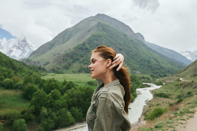 Rear view of woman standing on mountain