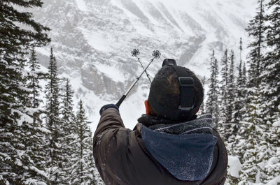 Rear view of man on snow covered land