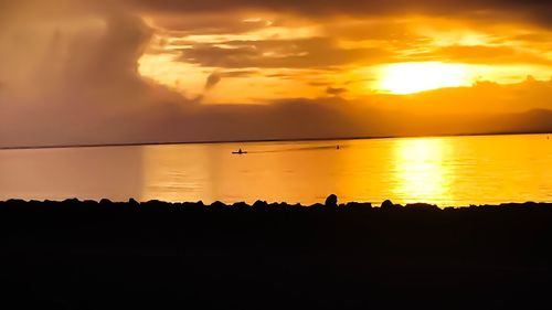 Scenic view of silhouette trees against orange sky