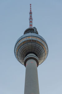 Low angle view of communications tower against sky