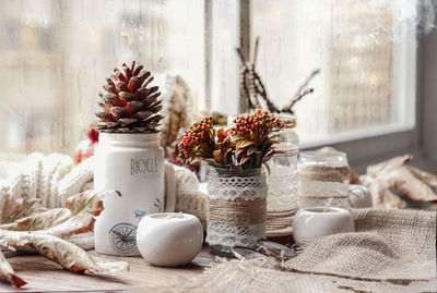 Flowers in glass jar on table