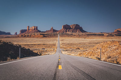 Road amidst rock formations against sky