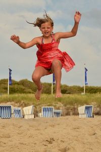 Full length of woman jumping in mid-air
