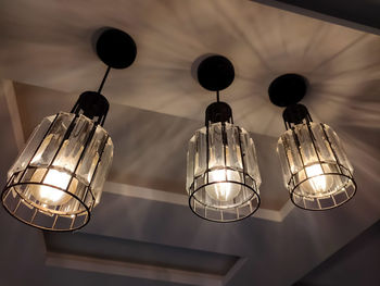 Low angle view of illuminated pendant light hanging from ceiling