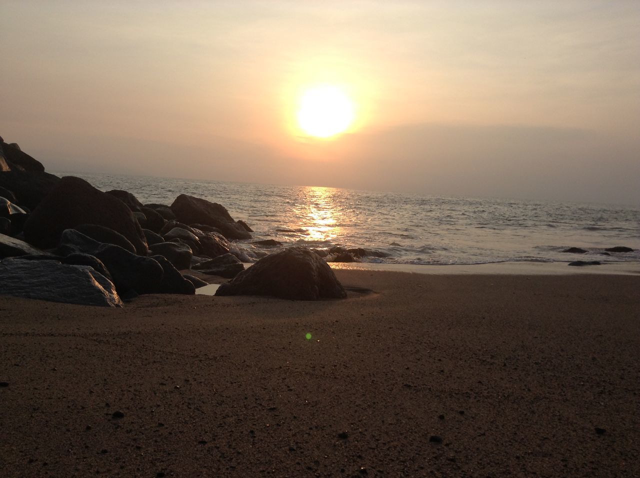 sea, horizon over water, water, sunset, beach, scenics, tranquil scene, sun, tranquility, beauty in nature, shore, sky, nature, idyllic, sunlight, rock - object, reflection, orange color, sand, coastline