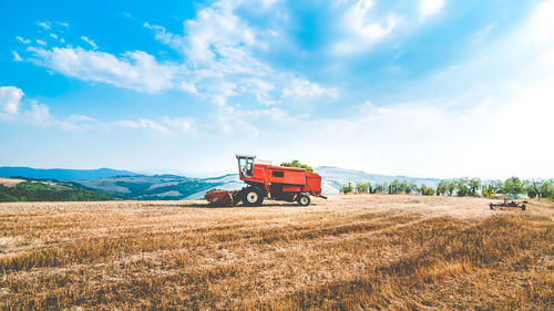 Tractor on field against sky