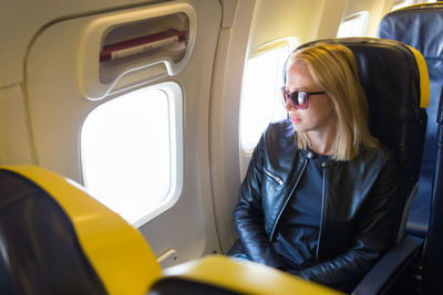 Beautiful woman sitting at airplane