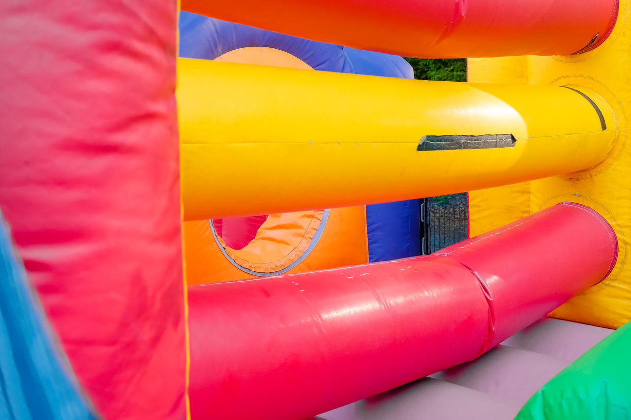 inflatable, yellow, red, game, playground, multi colored, playground slide, no people, close-up, vibrant color, pink, full frame, day, outdoors, tube