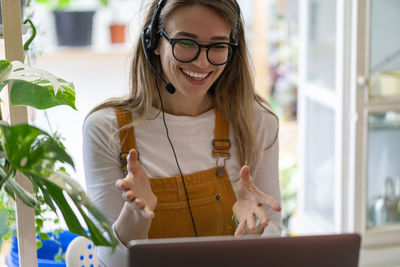 Smiling woman talking on video call at shop