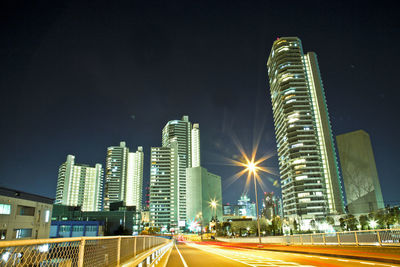 Illuminated cityscape against sky at night