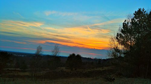 Scenic view of landscape against sky at sunset