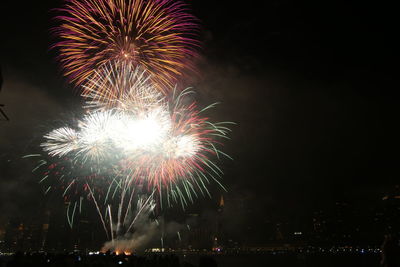 Low angle view of firework display at night