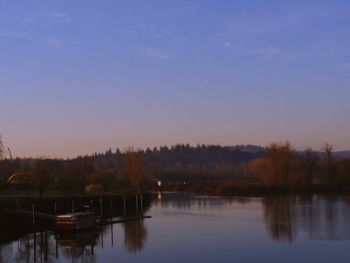 Scenic view of lake against sky at sunset