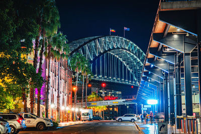 Illuminated bridge in city at night