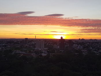 Silhouette cityscape against sky during sunset