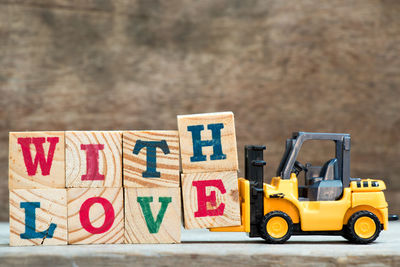 Close-up of text and toy car on table