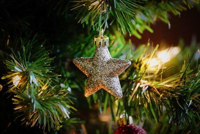Close-up of christmas decorations hanging on tree