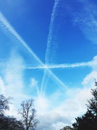 Low angle view of vapor trail against blue sky