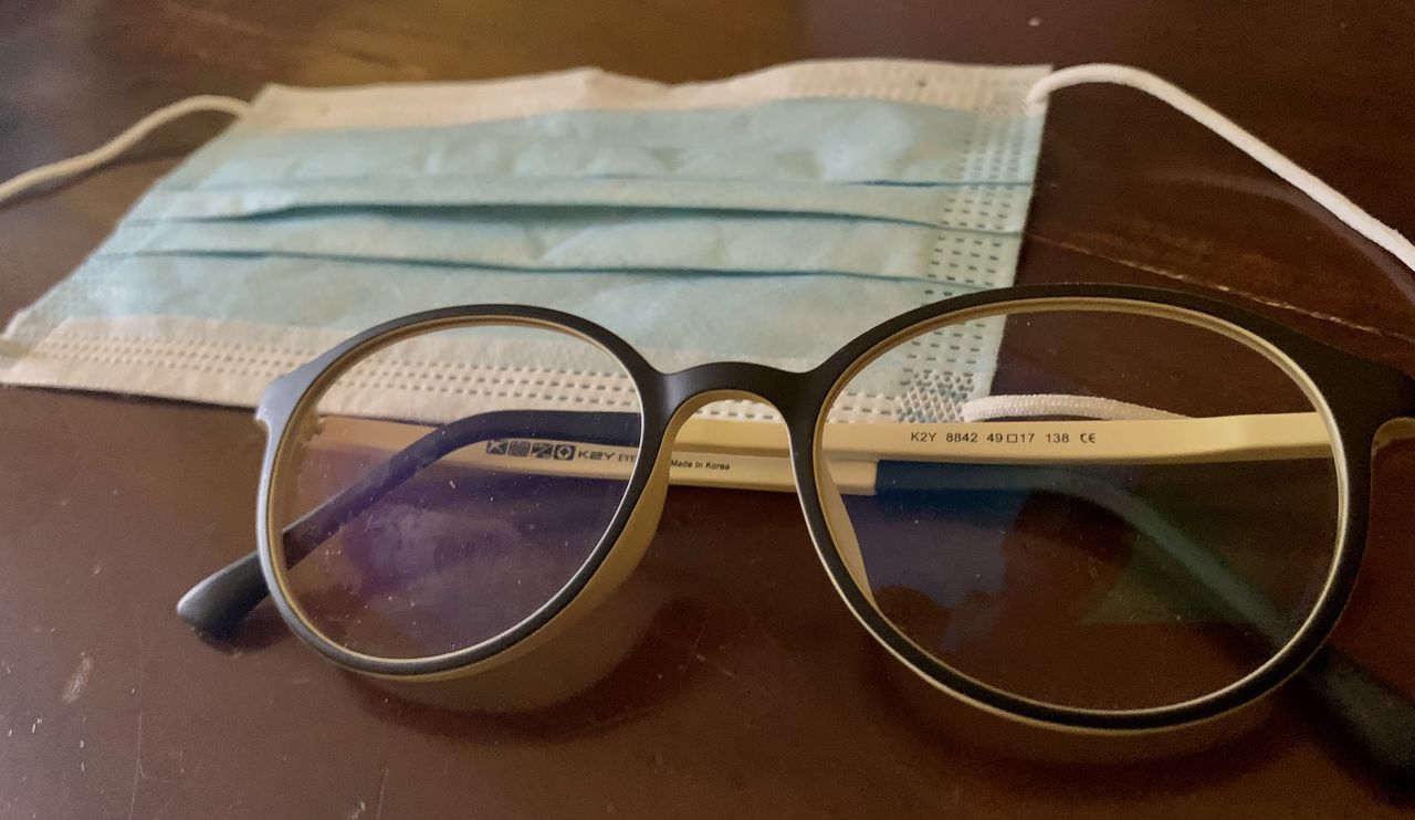 CLOSE-UP OF EYEGLASSES ON TABLE