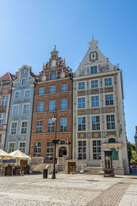 Low angle view of building against clear blue sky