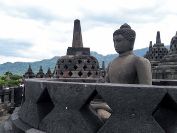 Statue of historic building against sky